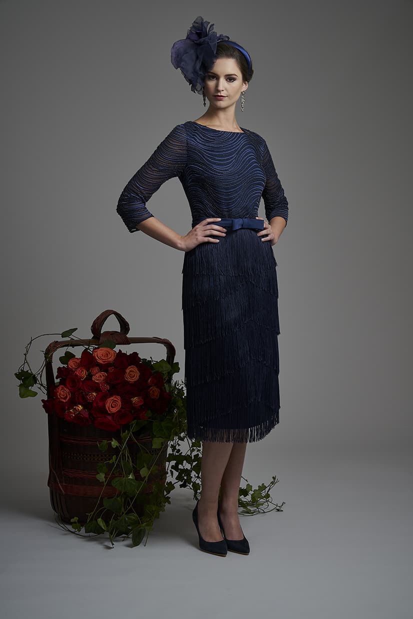 This stunning dress has been made by the finest ateliers and as such it is embellished y hand so no two pieces are alike. Fully lined this exquisite dress has one of the designers signature trademark of fringes making up the full skirt and 3/4 length sleeves. Round neckline and the bodice is covered in sequence. Royal blue- 5009 (004493)