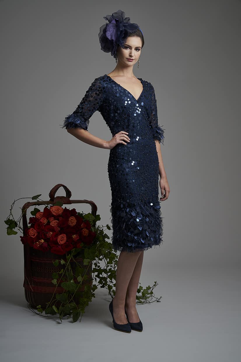 Disk and feather knee length dress with flattering v neck line and feather cuff detailing. This stunning dress has been made by the finest ateliers and as such it is embellished by hand so no two pieces are alike 5025 (004468)